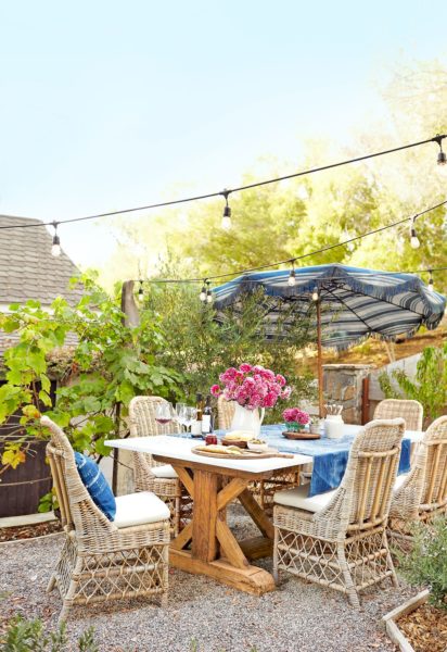 Create an outdoor oasis using a foldable umbrella and string bulbs | Front Porch Decorating Ideas